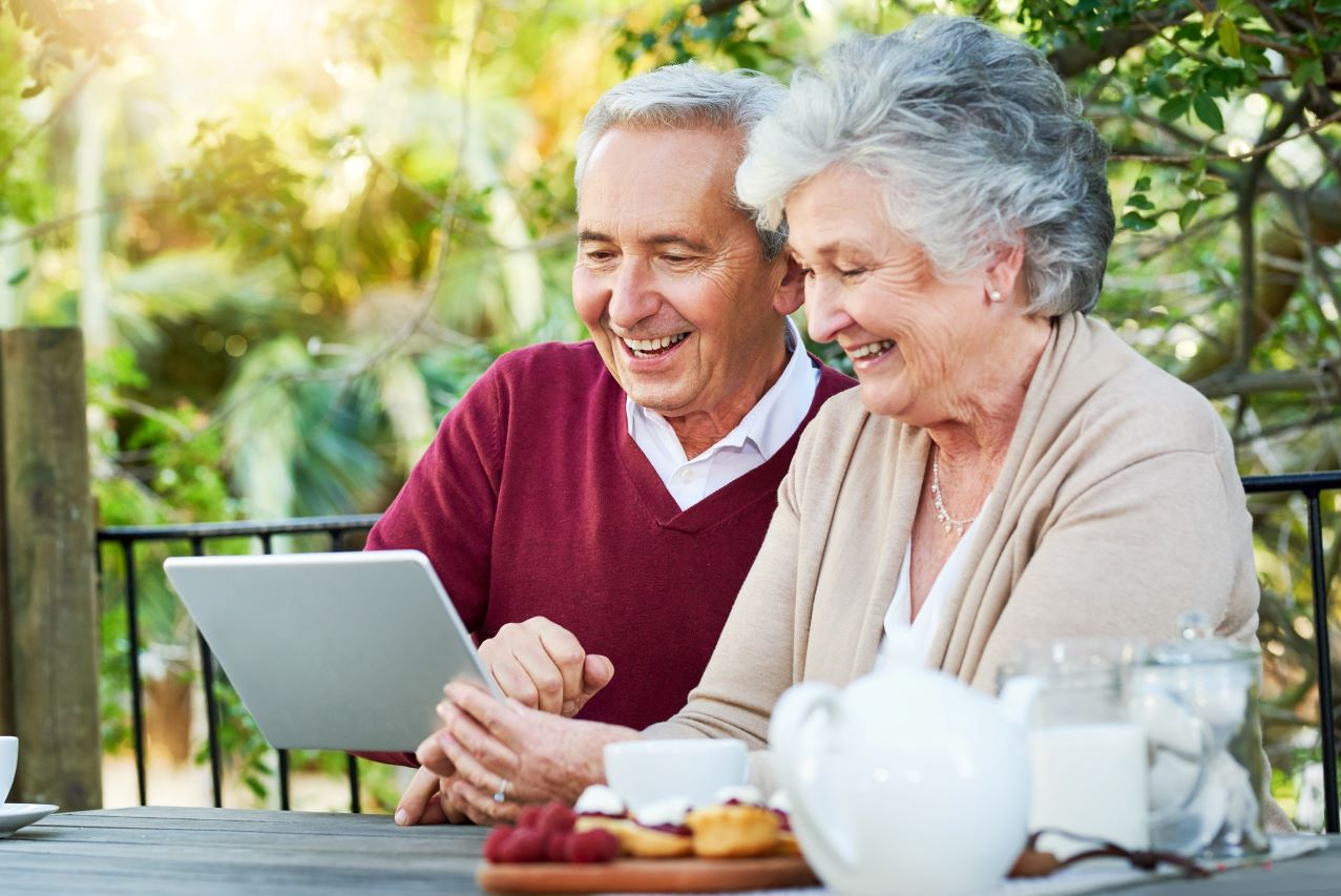 iStock-1126133008-couple-breakfast-table-outside-happy-1