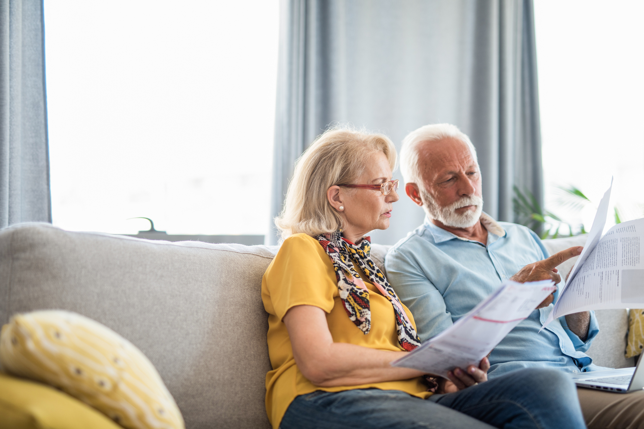 Worried senior couple taking care of bills.